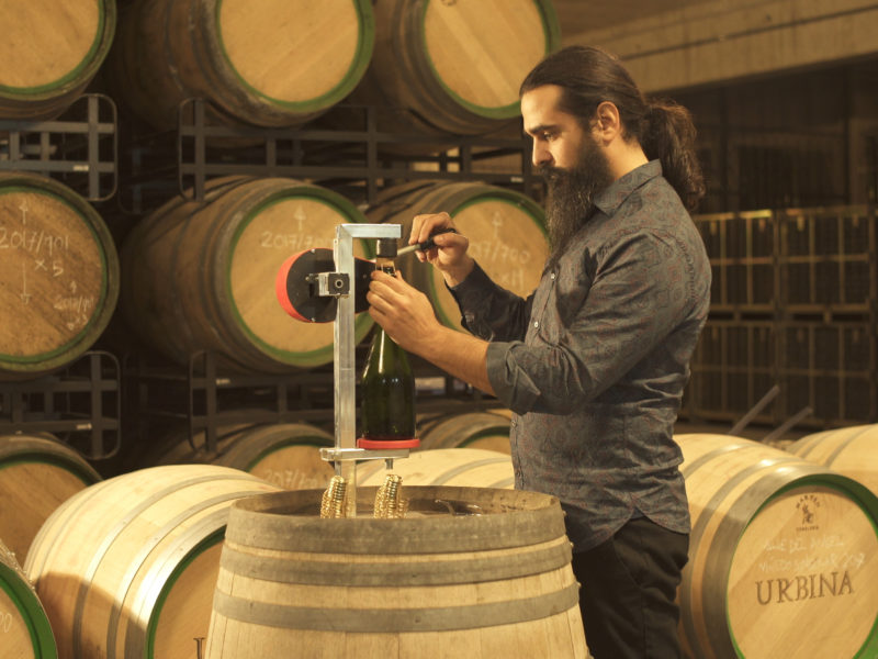 Enólogo colocando bozal en botella